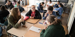Students engage in discussion in a classroom
