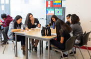 Female students work on a written assignment. 
