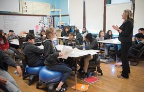 An educator speaks with a classroom full of middle school students.