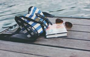 Book, purse, and sunglasses on a dock