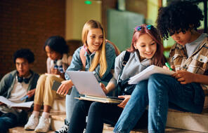  Group Of High School Students working together while learning