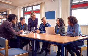  Educators collaborating in a library.