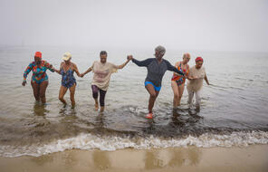Martha's Vineyard, MA - September 10: Peggy Barmore, center, an Inkwell Polar Bear for over 20 years, leads the bears out of Inkwell Beach in Oak Bluffs after their exercise. Every morning until late October, Polar Bears gather to swim, exercise and commune. Founded in 1946 as a safe space for Black swimmers, the Polar Bears of Martha's Vineyard have a rich history.