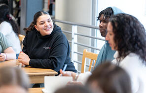 Students talking in the classroom.