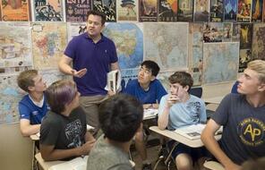 A teacher speaks to students in the classroom.