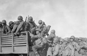 Soldiers from the 2nd Battalion, 442nd Regimental Combat Team climb into a truck as they prepare to move their bivouac area, Oct. 14, 1944, Chambois sector, France.