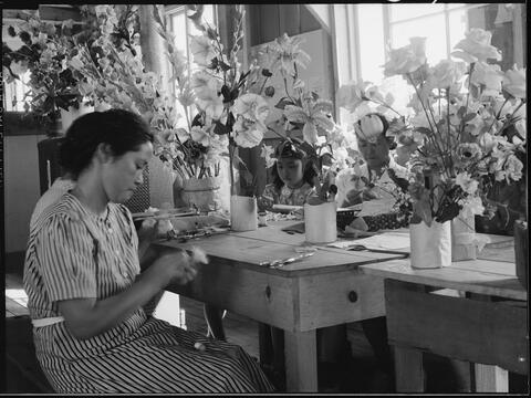 Manzanar Relocation Center, Manzanar, California. Making artificial flowers in the Art School at this War Relocation Authority center for evacuees of Japanese ancestry.