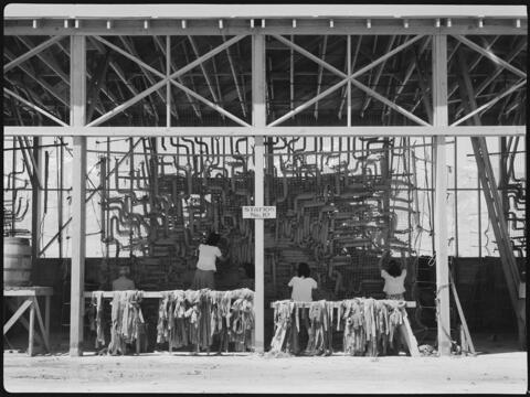 Making camouflage nets for the War Department. This is one of several War and Navy Department projects carried on by persons of Japanese ancestry in relocation centers.