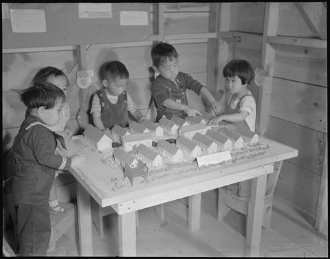 Nursery school children with model barracks.