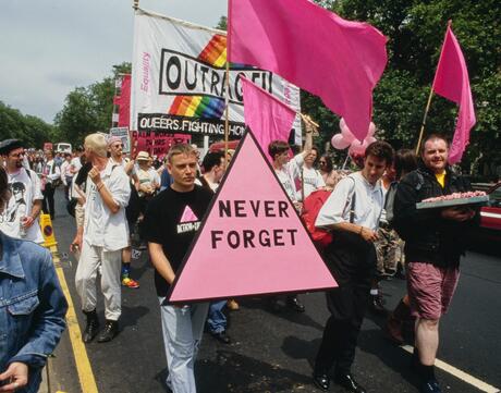 Marchers carrying a pink triangle with the words: 'Never Forget' at the Lesbian and Gay Pride event, London, 18th June 1994.