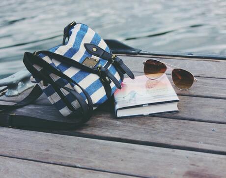 Book, purse, and sunglasses on a dock