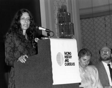 Black and white image of Carol Gilligan Speaking At Podium 