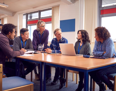  Educators collaborating in a library.