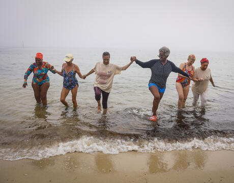 Martha's Vineyard, MA - September 10: Peggy Barmore, center, an Inkwell Polar Bear for over 20 years, leads the bears out of Inkwell Beach in Oak Bluffs after their exercise. Every morning until late October, Polar Bears gather to swim, exercise and commune. Founded in 1946 as a safe space for Black swimmers, the Polar Bears of Martha's Vineyard have a rich history.