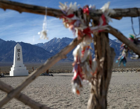 A white moument with brown symbols in the cemetery at Manzanar National Historic Site